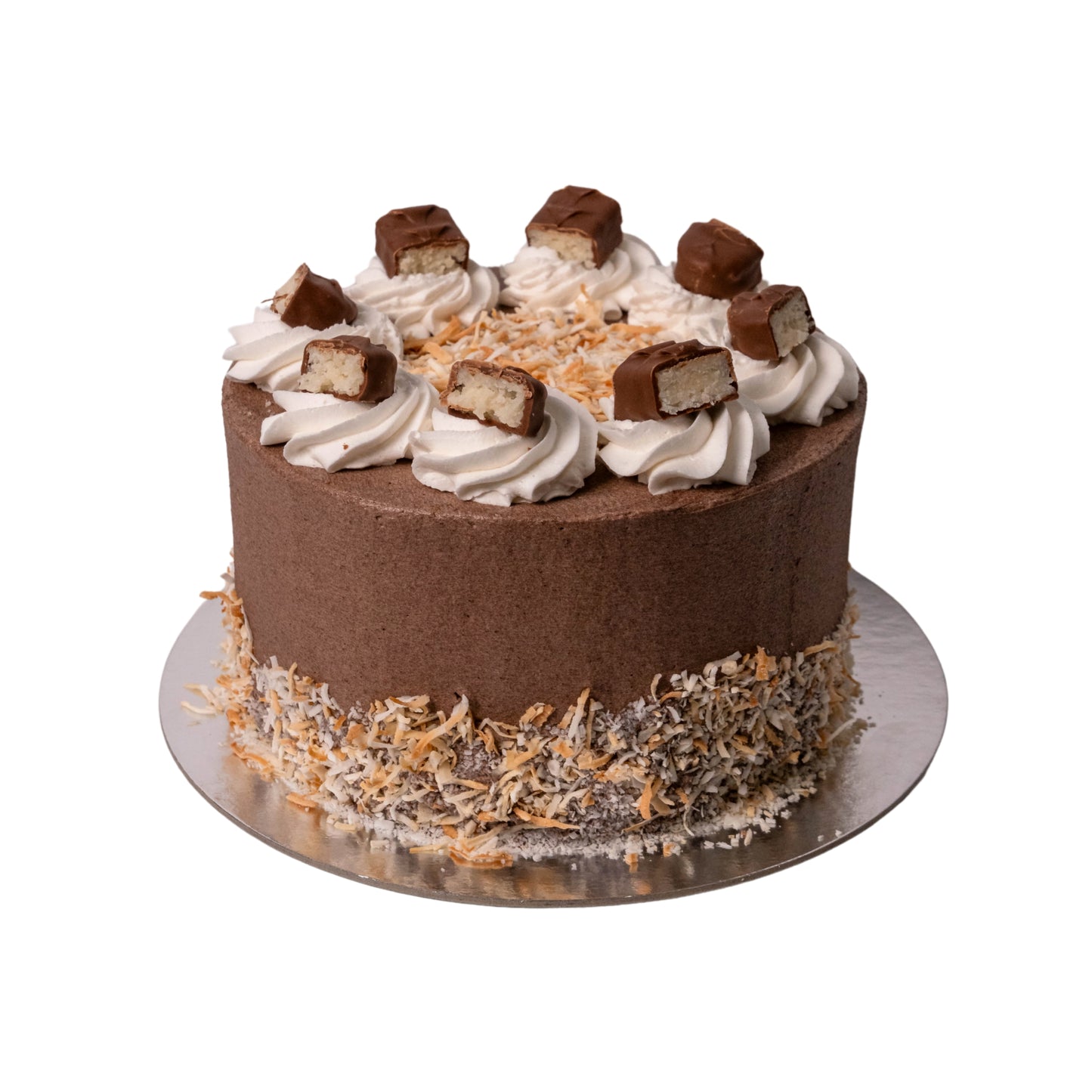 A chocolate cake with white whipped frosting, topped with chocolate sandwich cookies and shredded coconut, sitting on a silver cake board against a white background.