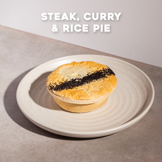 Steak, curry & rice pie on a plate with Bourkies Bakehouse branding.
