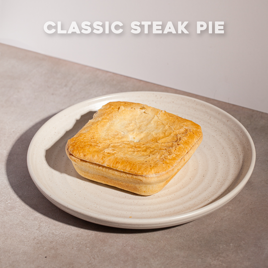 Classic steak pie on a plate with 'Bourkies Bakehouse' branding.
